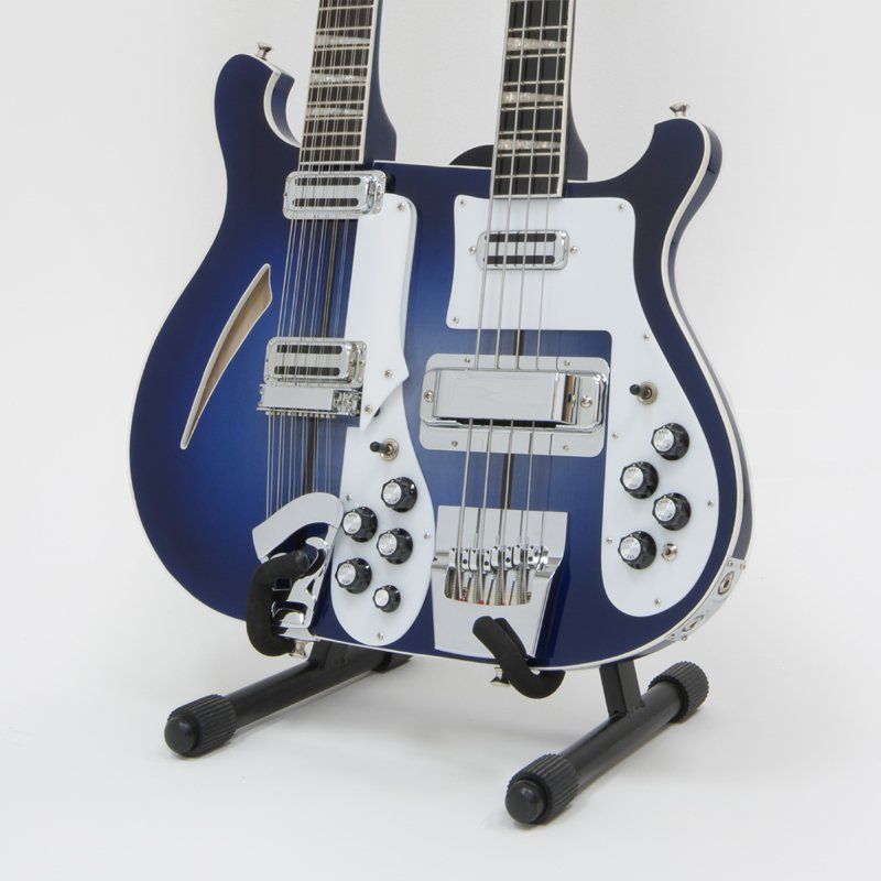 A blue double neck guitar is sitting on a stand