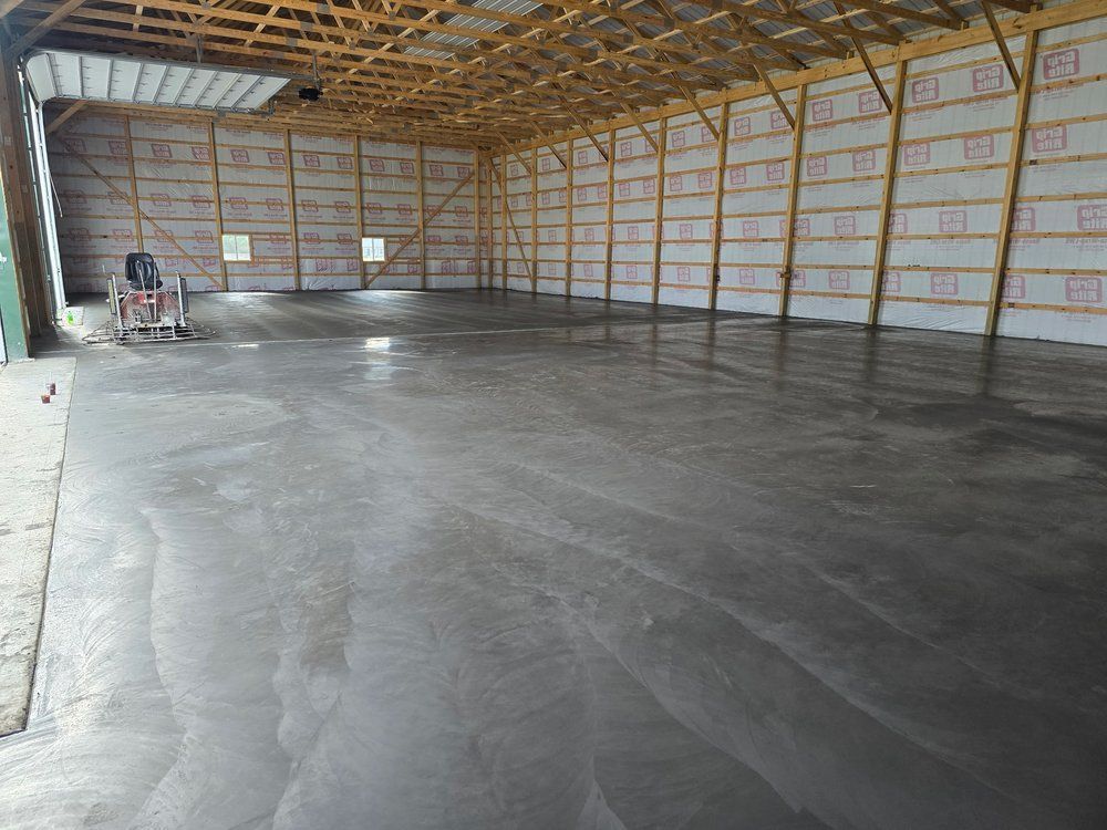 A large empty building with a concrete floor