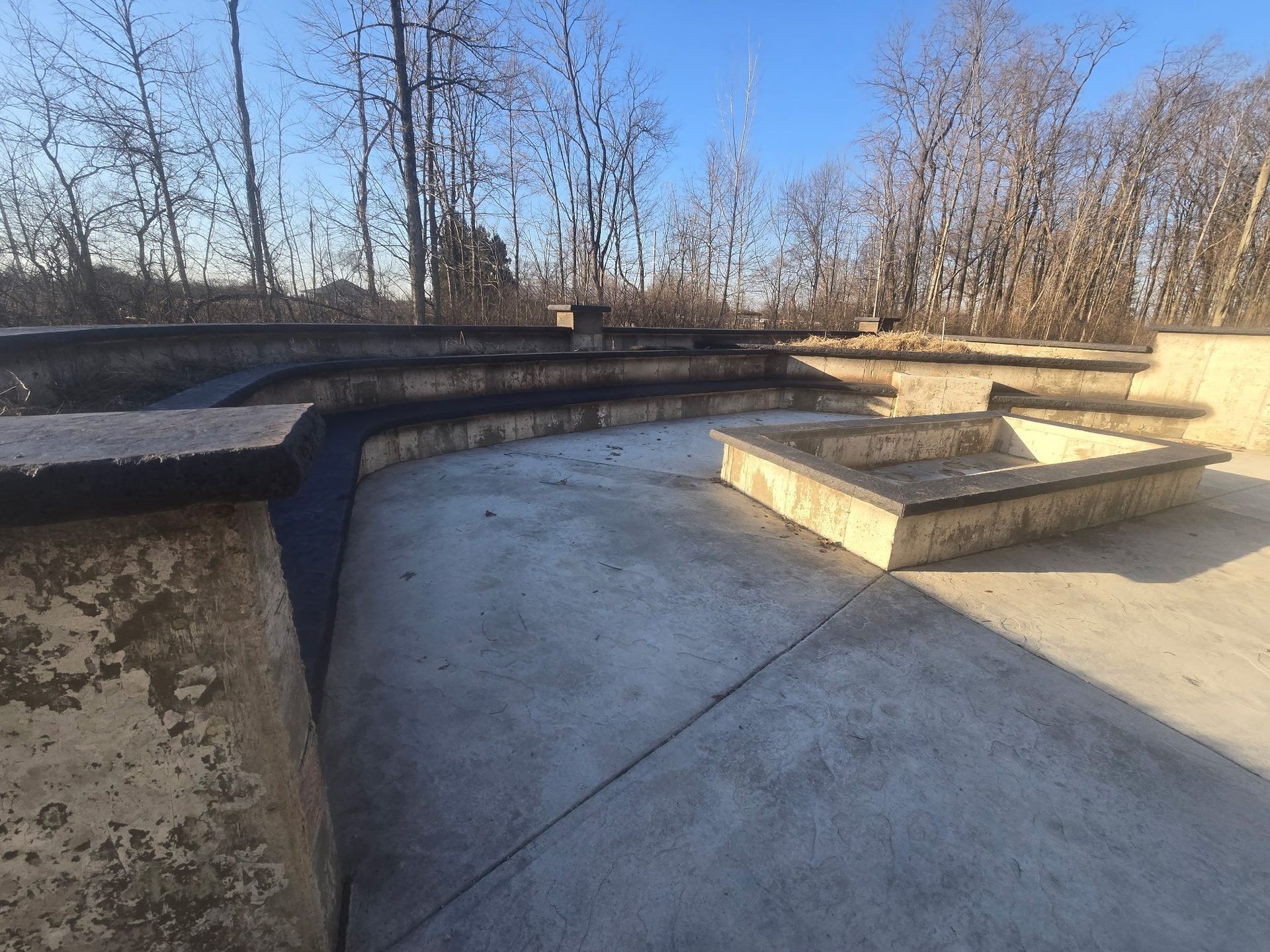 A concrete staircase with trees in the background