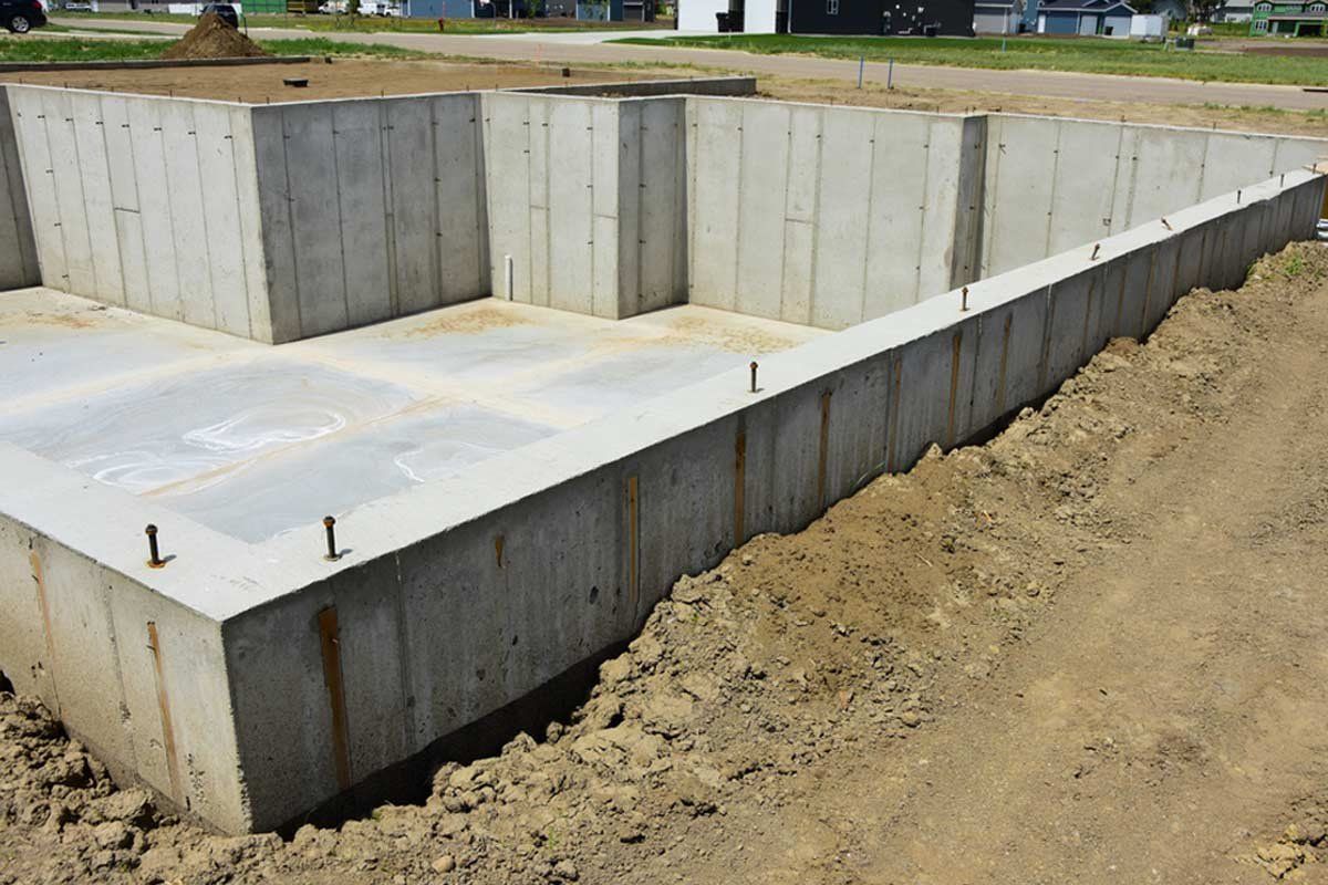 A concrete foundation for a house is being built