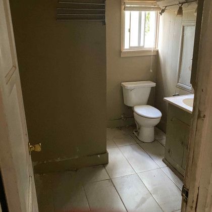 Bathroom with a toilet and window.