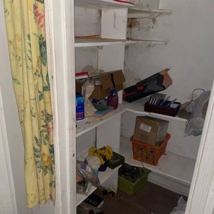 A closet filled with lots of shelves and boxes.
