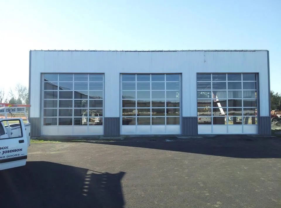 Commercial overhead garage door with glass panels installed in Chehalis, WA by Johnson & Johnson