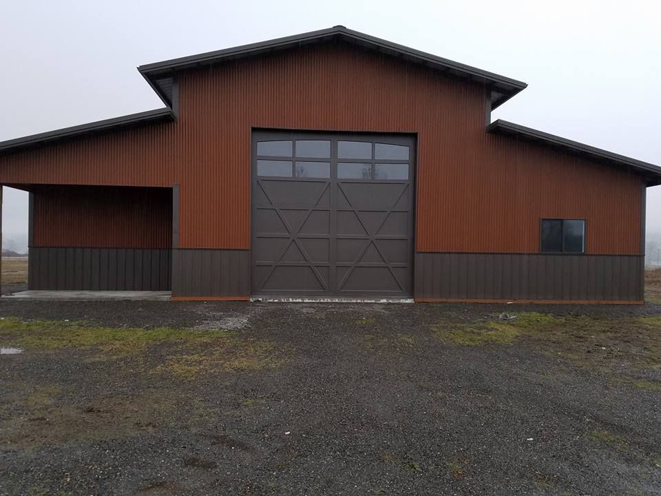 Large barn-style garage door on residential shop building