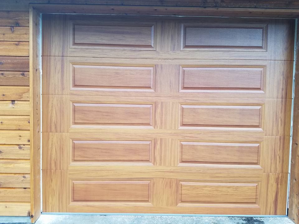 Residential wood toned garage door in Centralia, WA installed by Johnson & Johnson Overhead Door