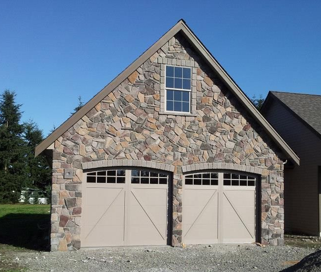 Detached double car garage with custom doors provided by Johnson & Johnson Overhead Doors INC in Lacey, WA