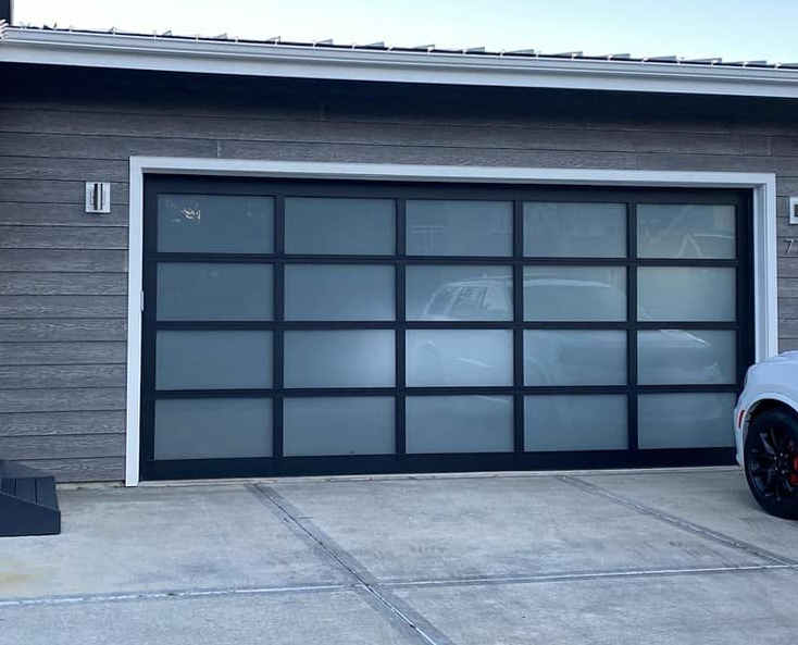 Modern glass panel garage door on a contemporary home with clean architectural design