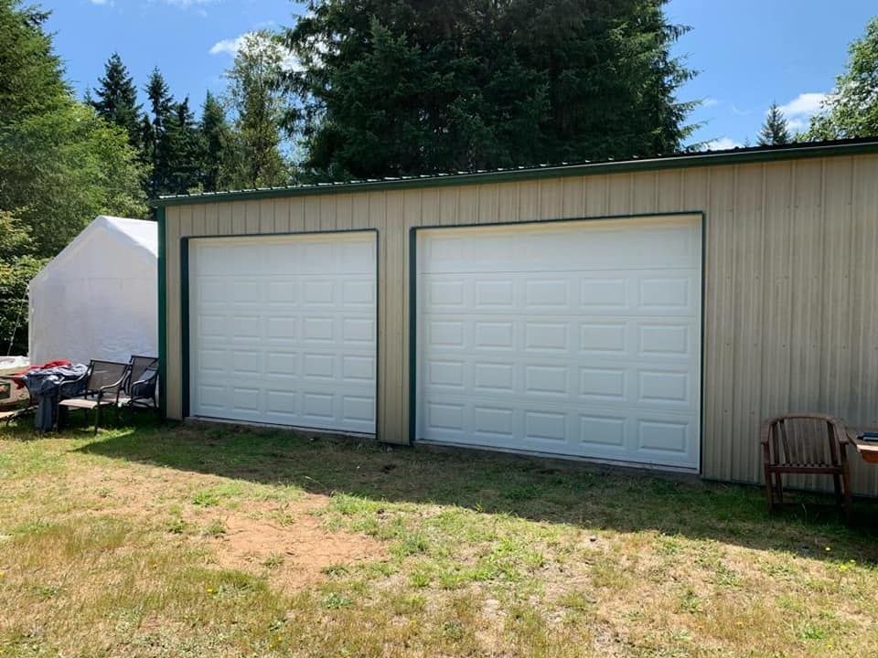 Two white garage doors on detached residential garage