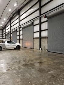 Commercial building interior with multiple overhead garage doors installed