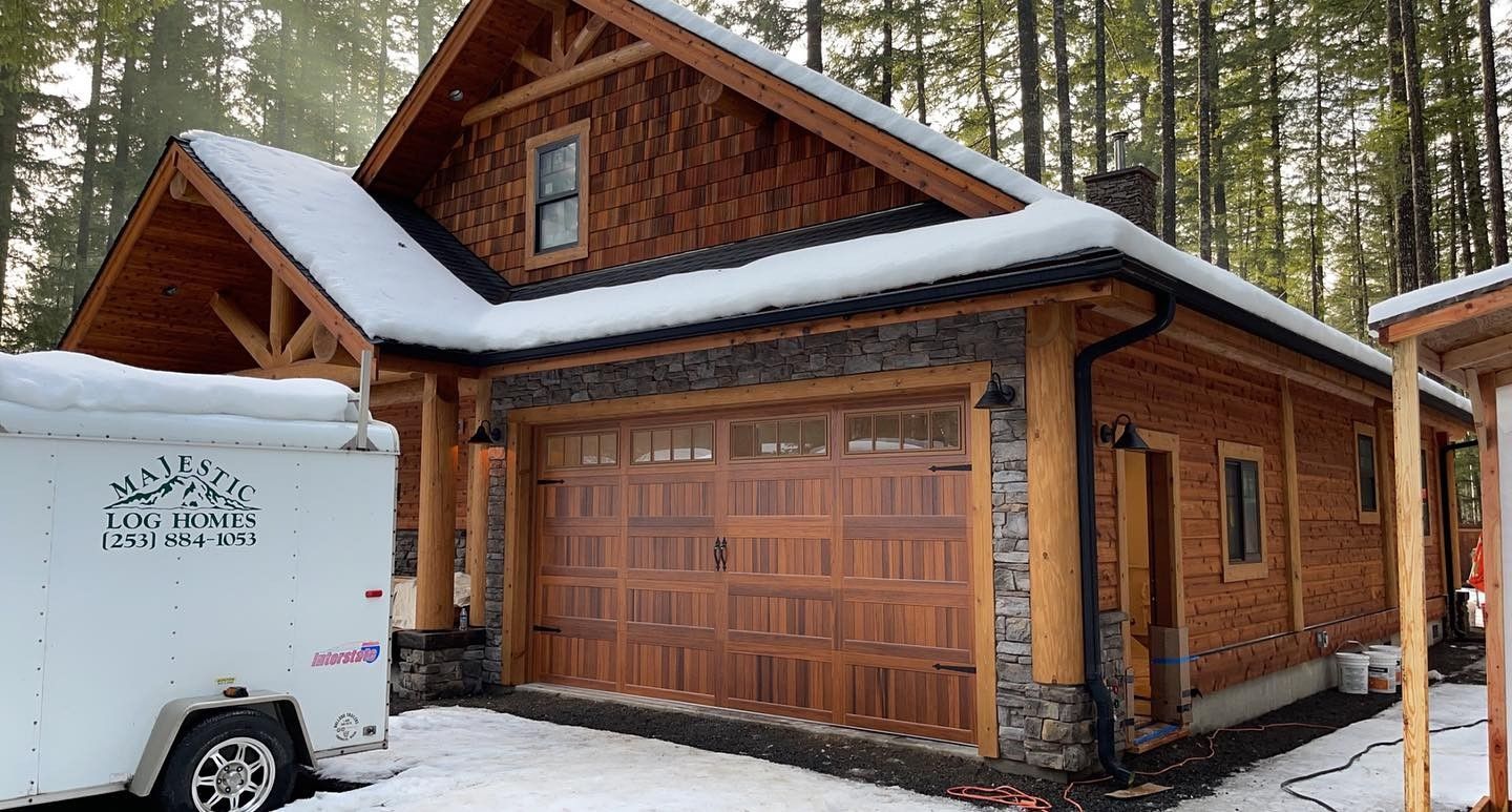Cabin with rustic garage door provided by Johnson & Johnson Overhead Door INC
