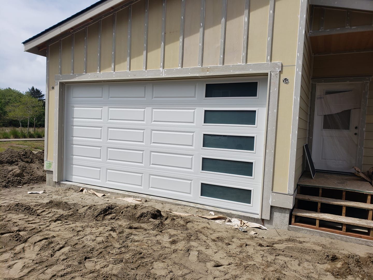 White garage door with horizontal windows on new construction home