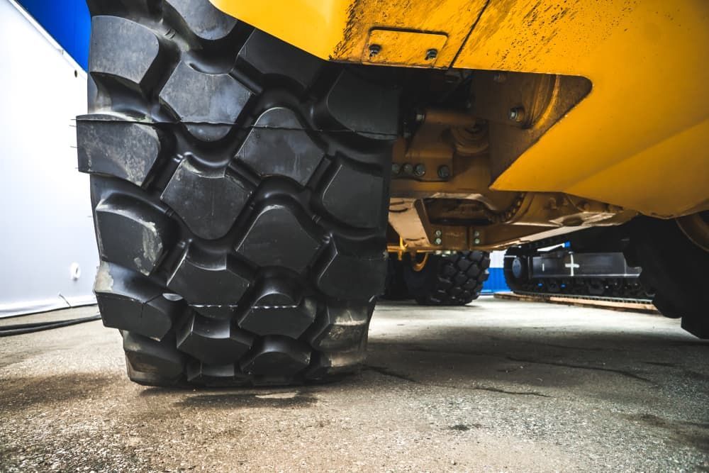 A close up of a large tire on a yellow truck. — KBX Mechanical In Paget, QLD