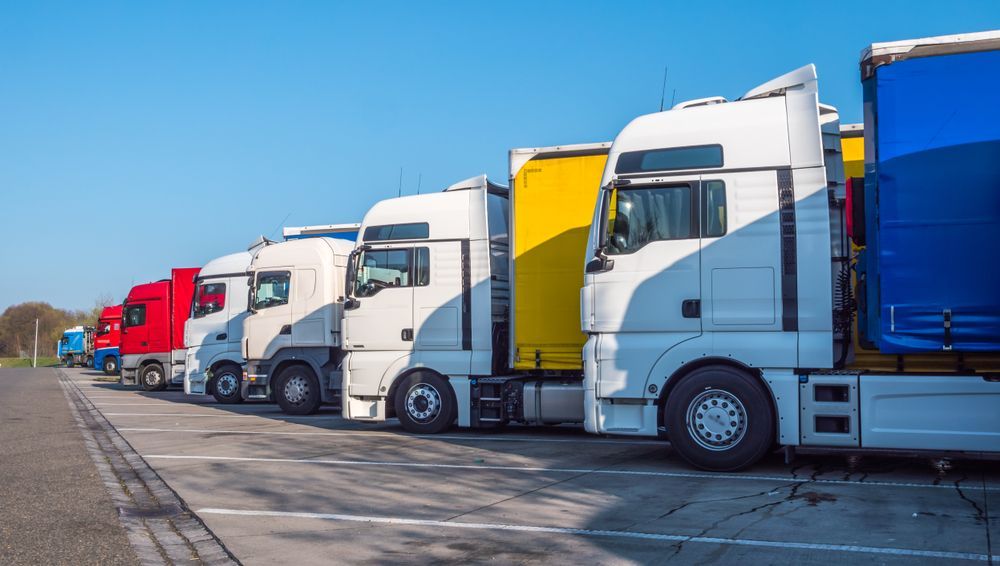 A Row Of Semi Trucks Parked In A Parking Lot — KBX Mechanical In Mackay, QLD
