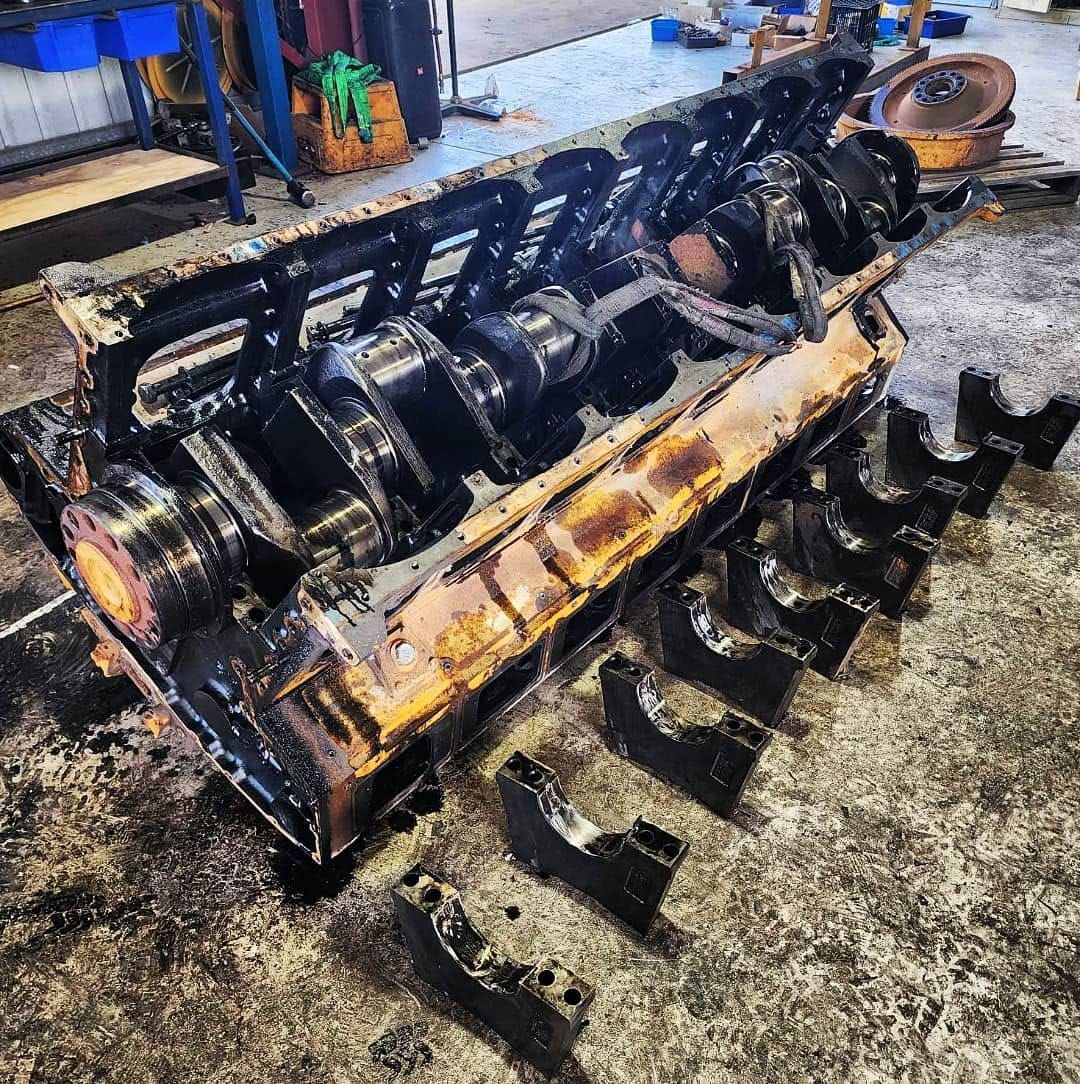 A large engine block is sitting on the ground in a garage. — KBX Mechanical In Paget, QLD