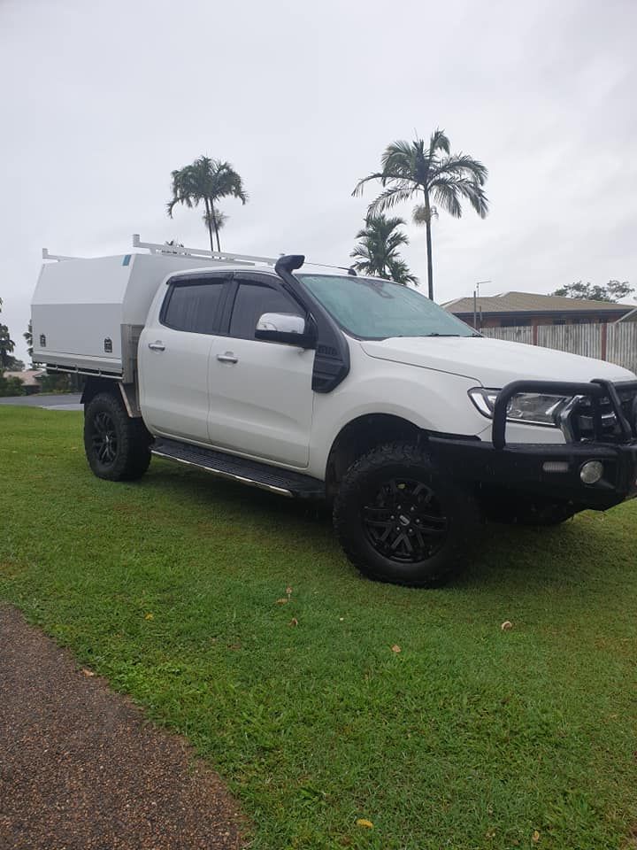 A White Ute Parked On Grass — KBX Mechanical In Paget, QLD