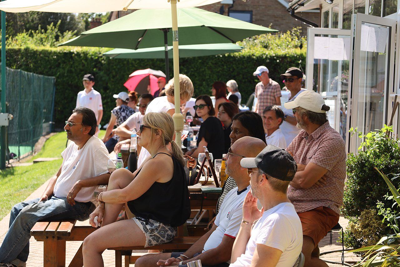 A crowd watching matches at Pinner Lawn Tennis Club