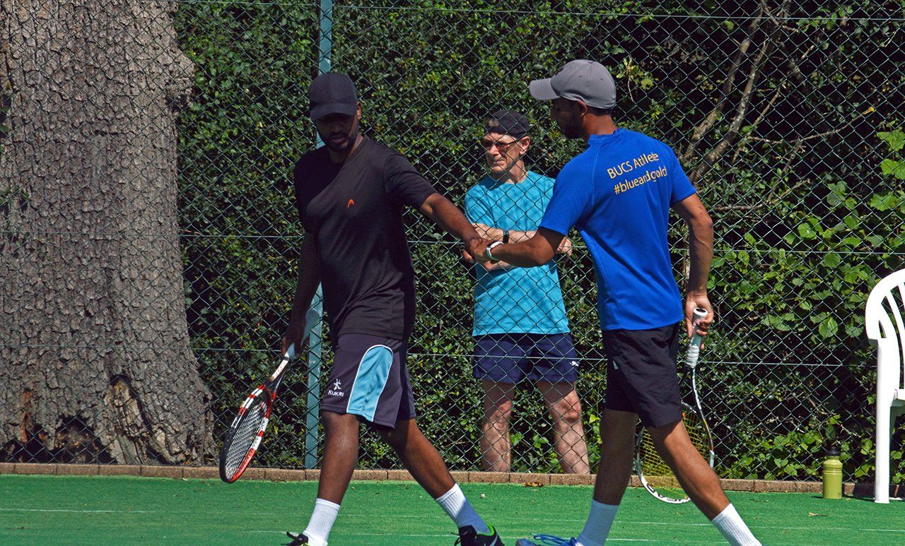 An image of two male doubles tennis players at Pinner Lawn Tennis Club