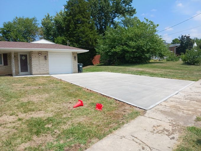 A house with a concrete driveway in front of it