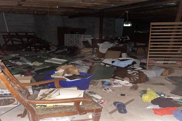 basement that is full of trash and furniture