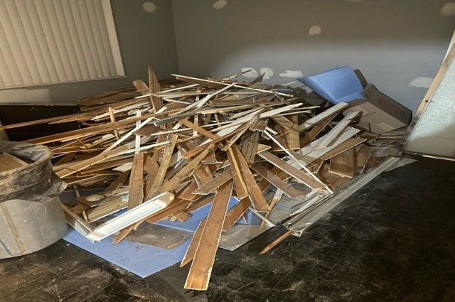 Pile of construction debris, mostly broken up wood trim