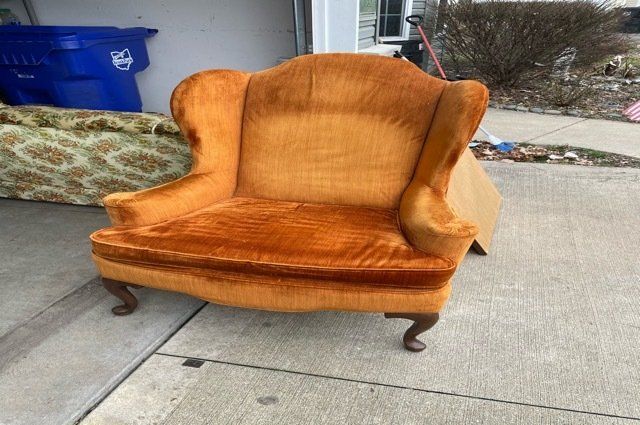 Old Orange Chair Sitting In Deiveway