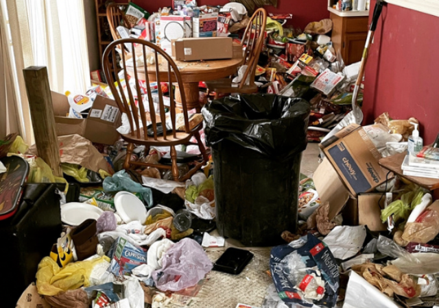 piles of trash covering the floor in a hoarders home
