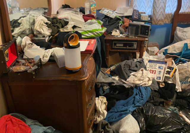 a pile of trash inside a hoarder house that is filling up the whole room