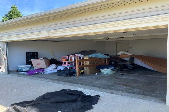 miscellaneous furniture and garbage inside garage