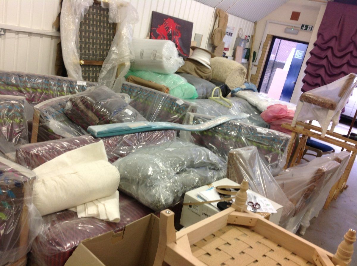 piles of old wrapped up furniture that is going to be donated