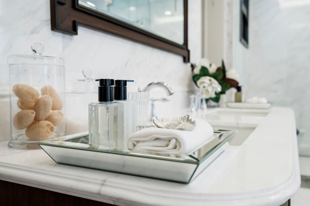 A Bathroom Counter With A Tray Of Towels And Soap On It — Viison Kitchens & Joinery Forster In Forster, NSW