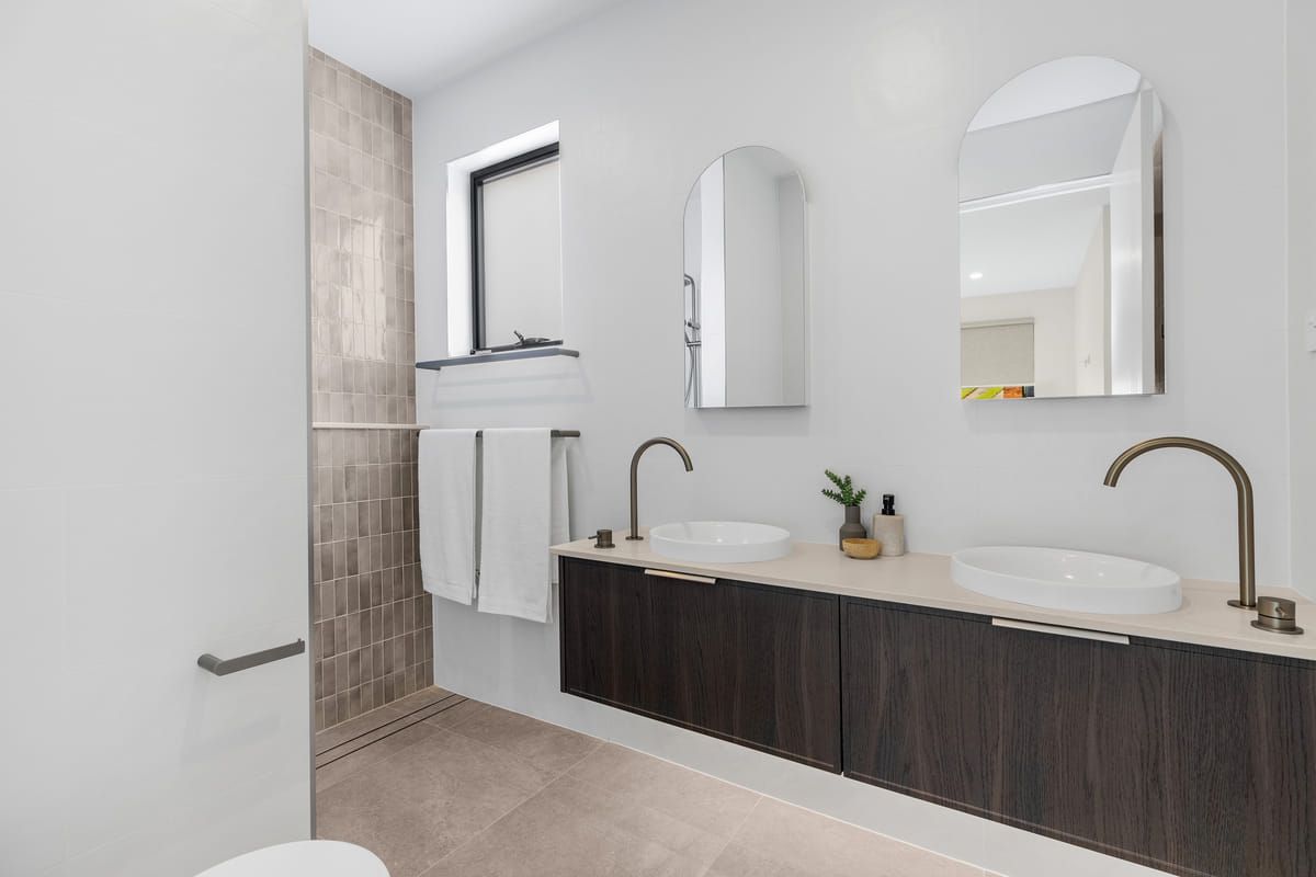 A Bathroom With A Toilet , Sink , Mirror And Towel Rack — Viison Kitchens & Joinery Forster In Forster, NSW