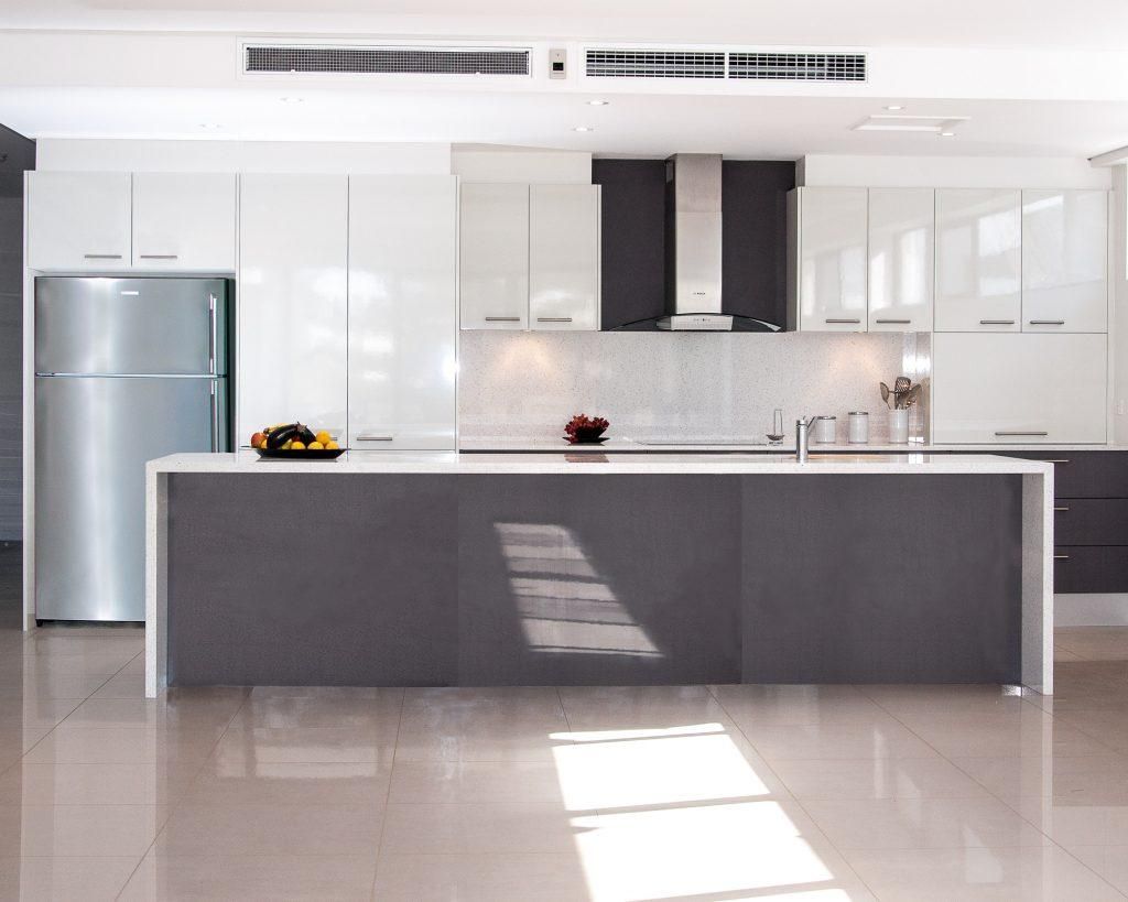 A Kitchen With Green Cabinets And A Large Island In The Middle — Viison Kitchens & Joinery Forster In Newcastle, NSW