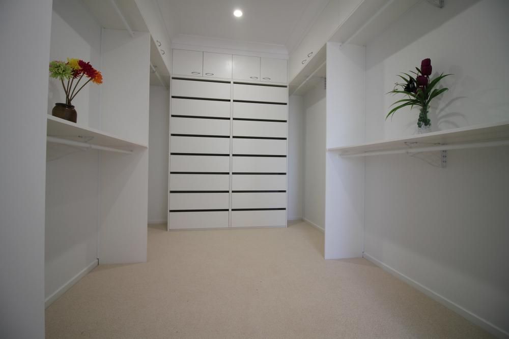 There Are Two Vases Of Flowers On The Shelves In The Closet — Viison Kitchens & Joinery Forster In Taree, NSW