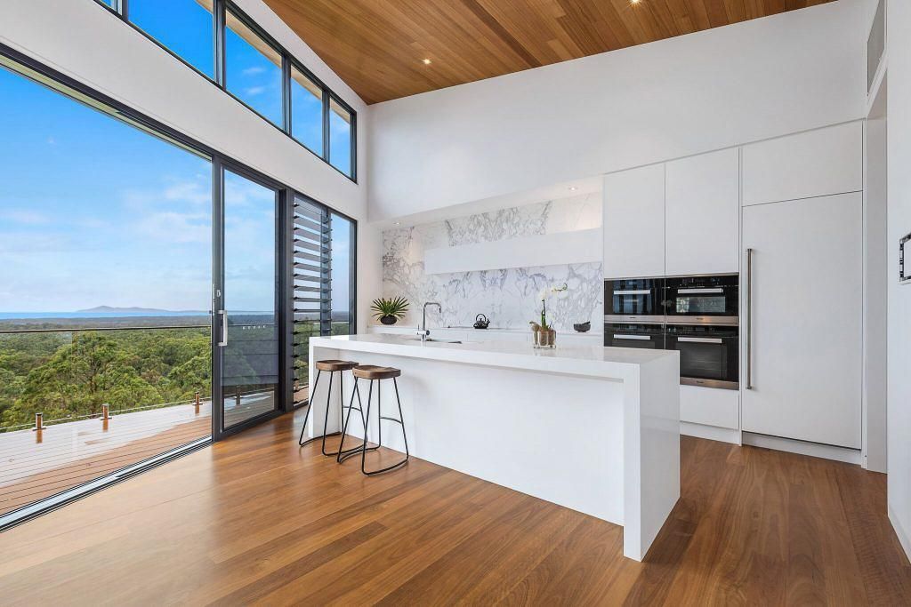 A Kitchen With A Large Island And Stools And A View Of A Vineyard — Viison Kitchens & Joinery Forster In Forster, NSW