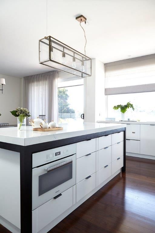 A Kitchen With A Large Island And White Cabinets — Viison Kitchens & Joinery Forster In Old Bar, NSW