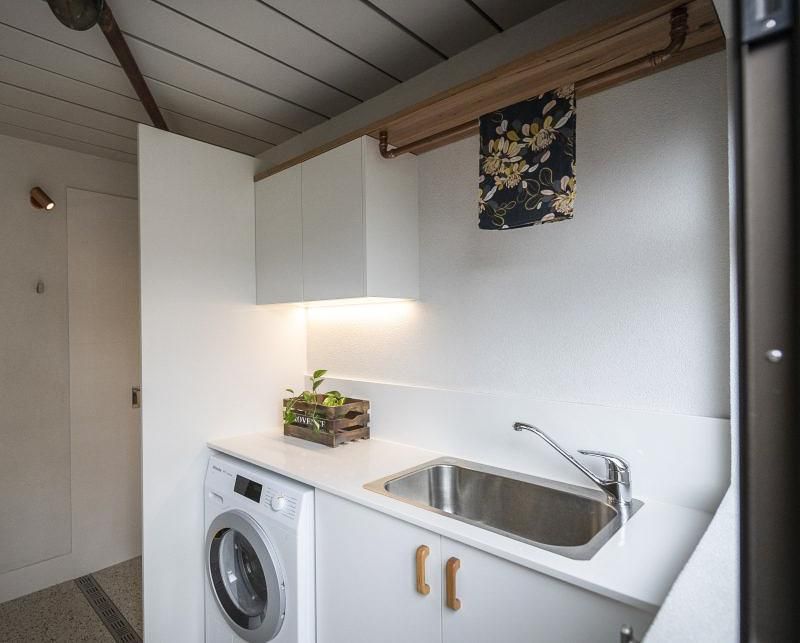 A Laundry Room With A Washer And Dryer And A Sink — Viison Kitchens & Joinery Forster In Forster, NSW