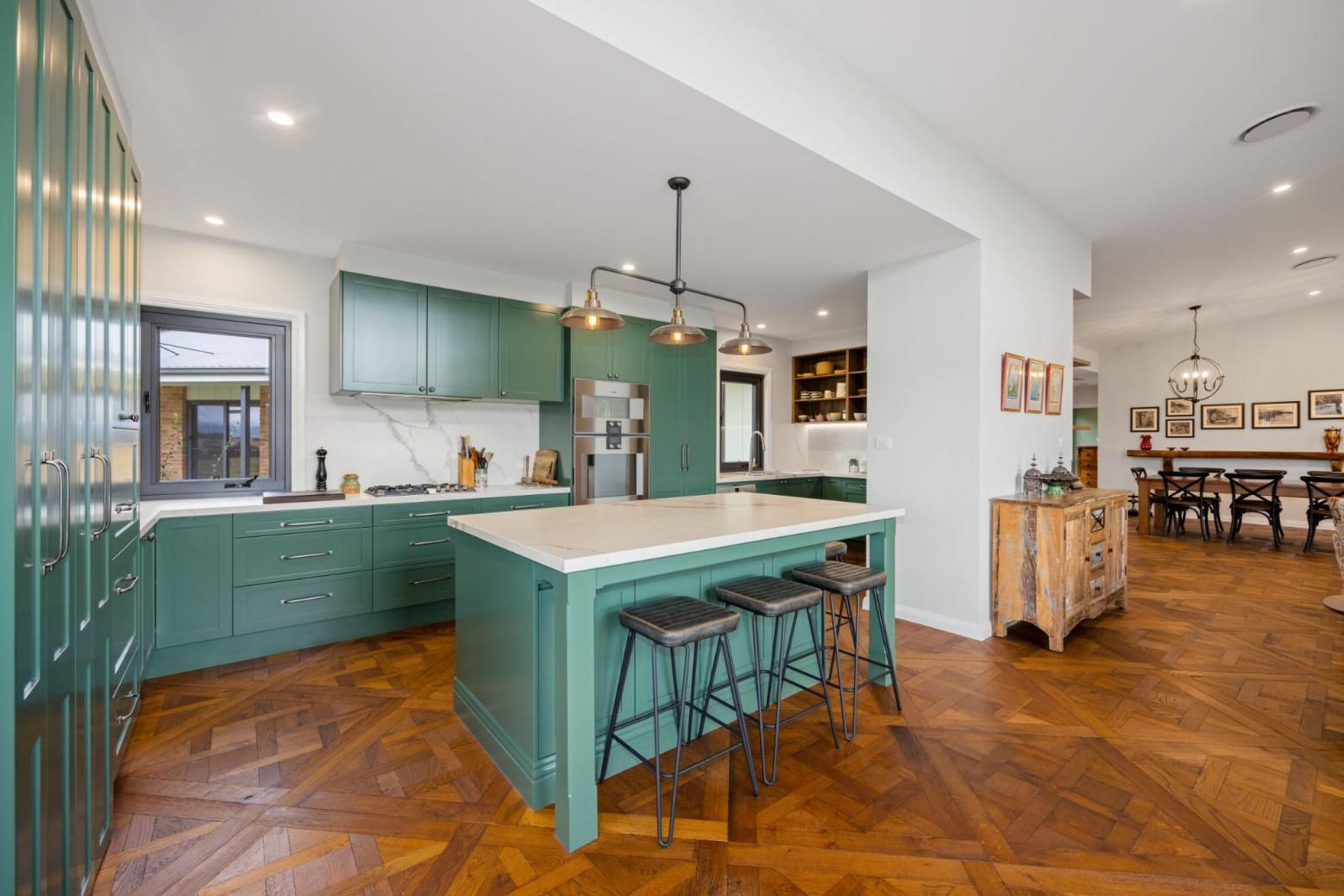 A Kitchen With Green Cabinets And A Large Island In The Middle — Viison Kitchens & Joinery Forster In Forster, NSW