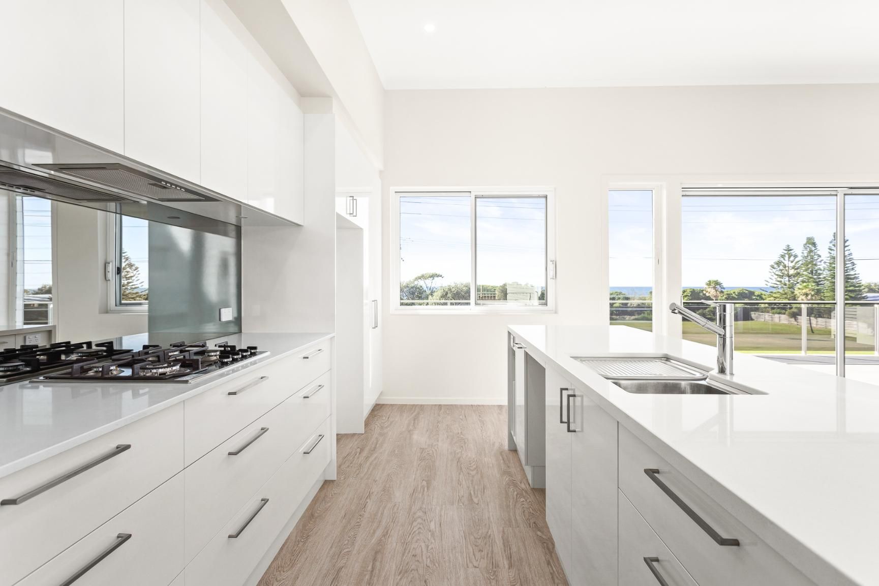 A Kitchen With White Cabinets , A Stove Top Oven — Viison Kitchens & Joinery Forster In Kempsey, NSW