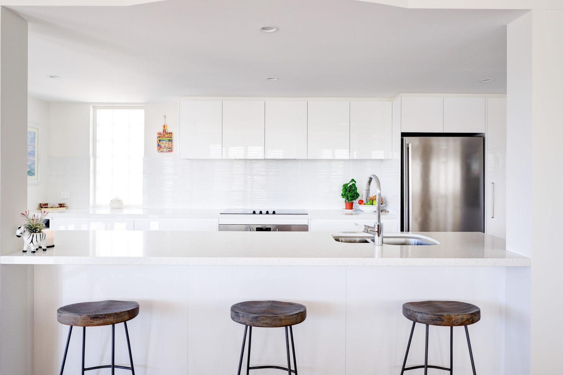 A Kitchen With White Cabinets And Stools — Viison Kitchens & Joinery Forster In Forster, NSW