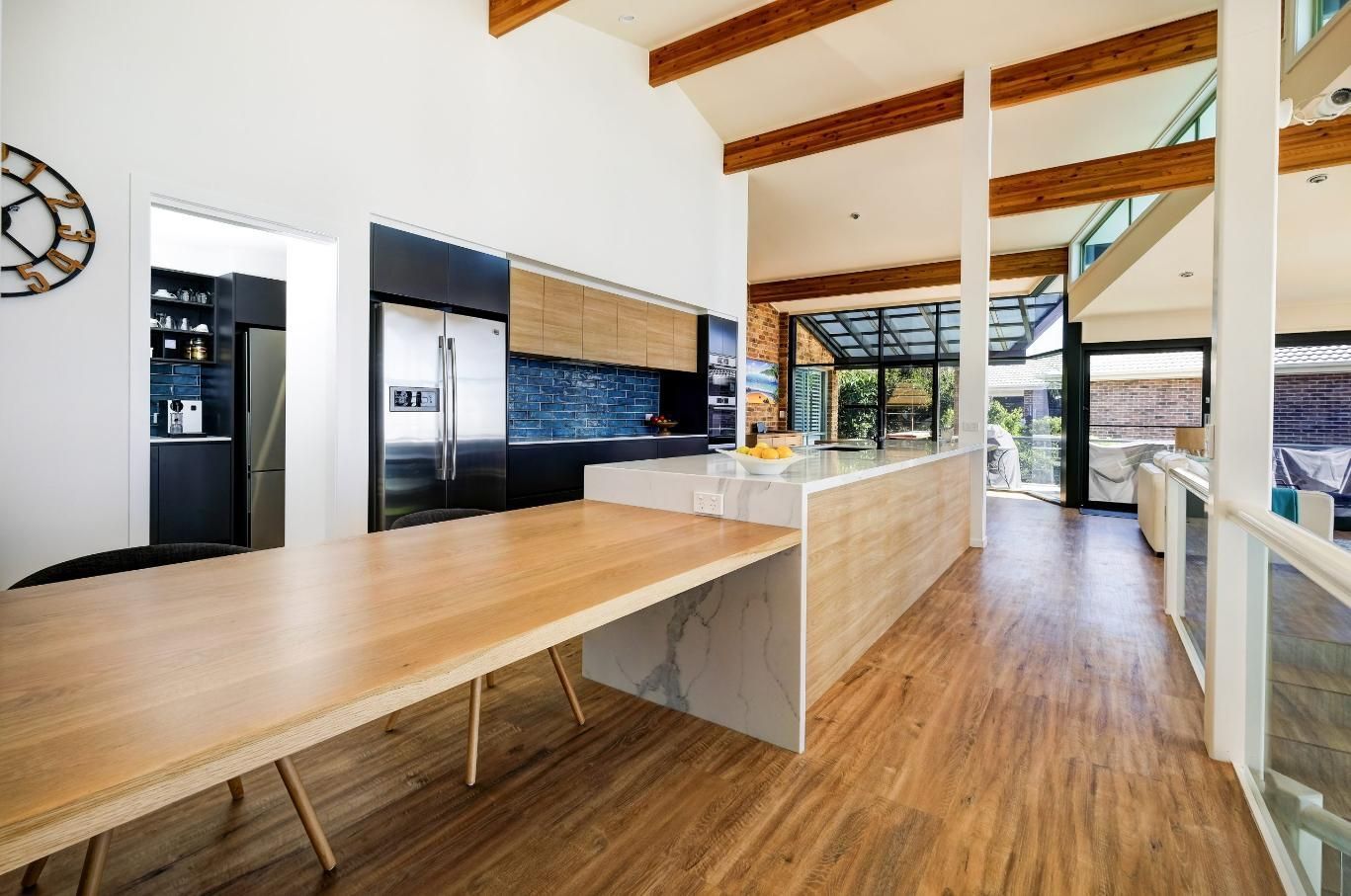 A Kitchen With A Long Wooden Table In The Middle Of It — Viison Kitchens & Joinery Forster In Forster, NSW
