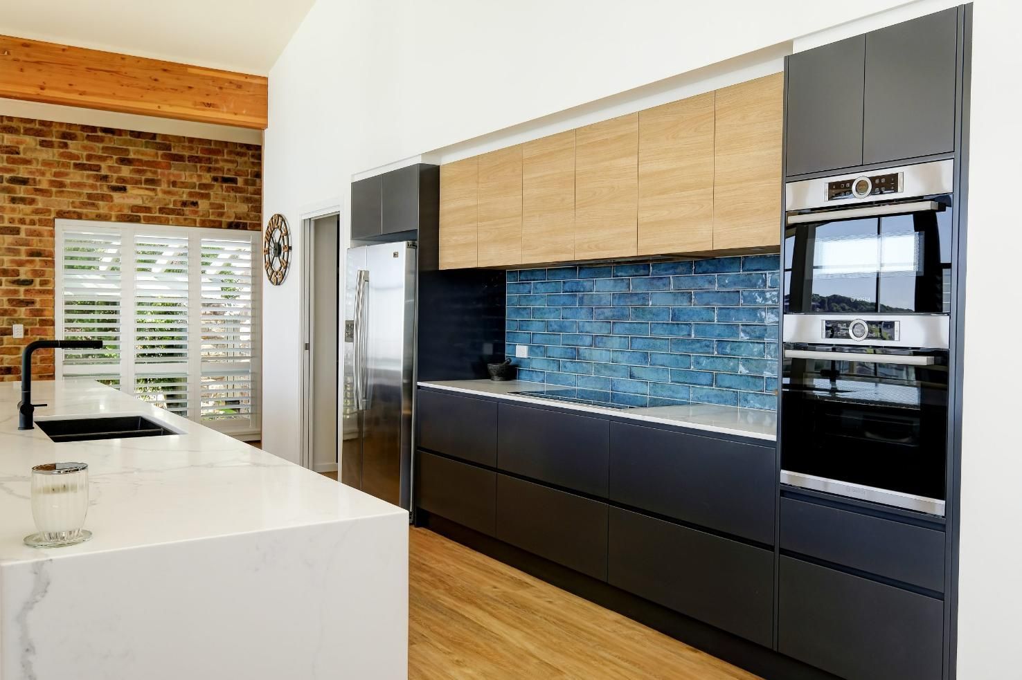 A Kitchen With Stainless Steel Appliances And Wooden Cabinets — Viison Kitchens & Joinery Forster In Forster, NSW