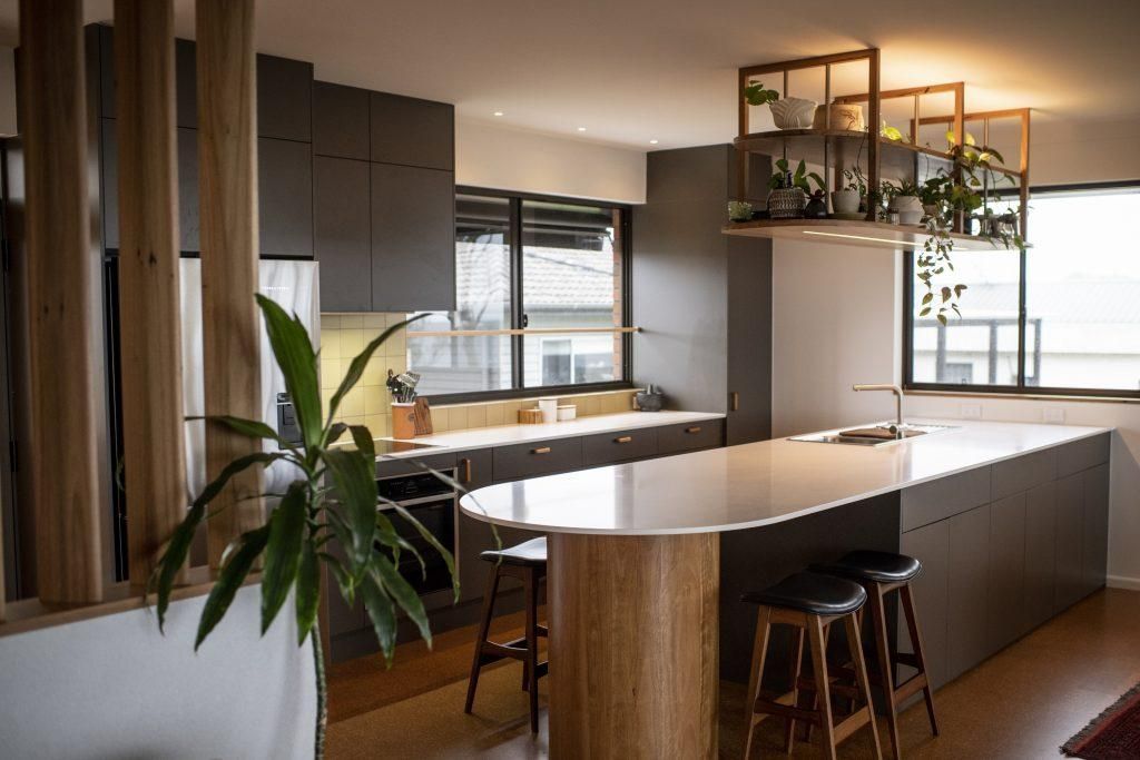 A Kitchen With A Large Island , Stools And A Plant — Viison Kitchens & Joinery Forster In Wingham, NSW