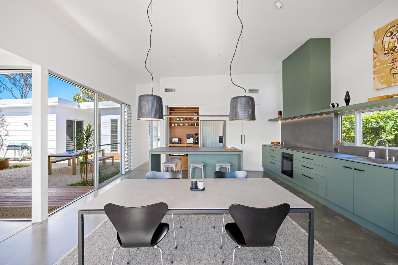 A Kitchen With A Table And Chairs In It — Viison Kitchens & Joinery Forster In Forster, NSW