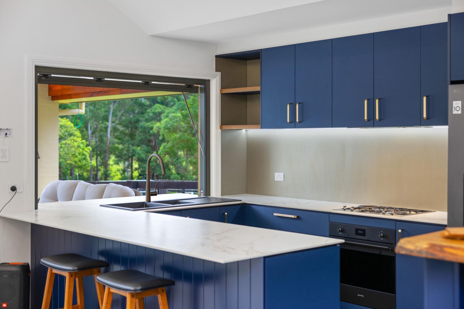 A Kitchen With Blue Cabinets , White Counter Tops , And A Large Island — Viison Kitchens & Joinery Forster In Forster, NSW