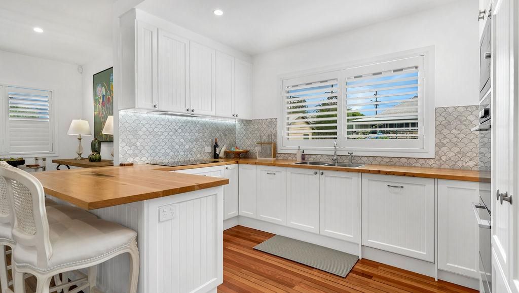 A Kitchen With White Cabinets And Hardwood Floors — Viison Kitchens & Joinery Forster In Port Macquarie, NSW