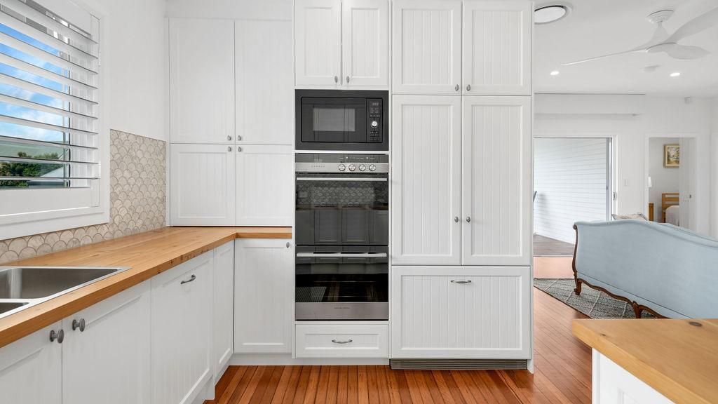 A Kitchen With White Cabinets , Wooden Counter Tops — Viison Kitchens & Joinery Forster In Forster, NSW