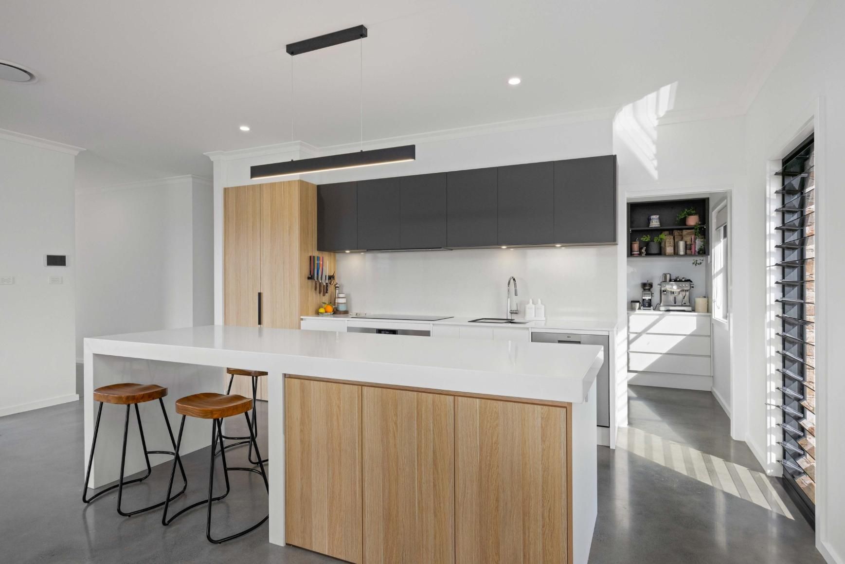A Kitchen With A Large Island And Stools In It — Viison Kitchens & Joinery Forster In Forster, NSW