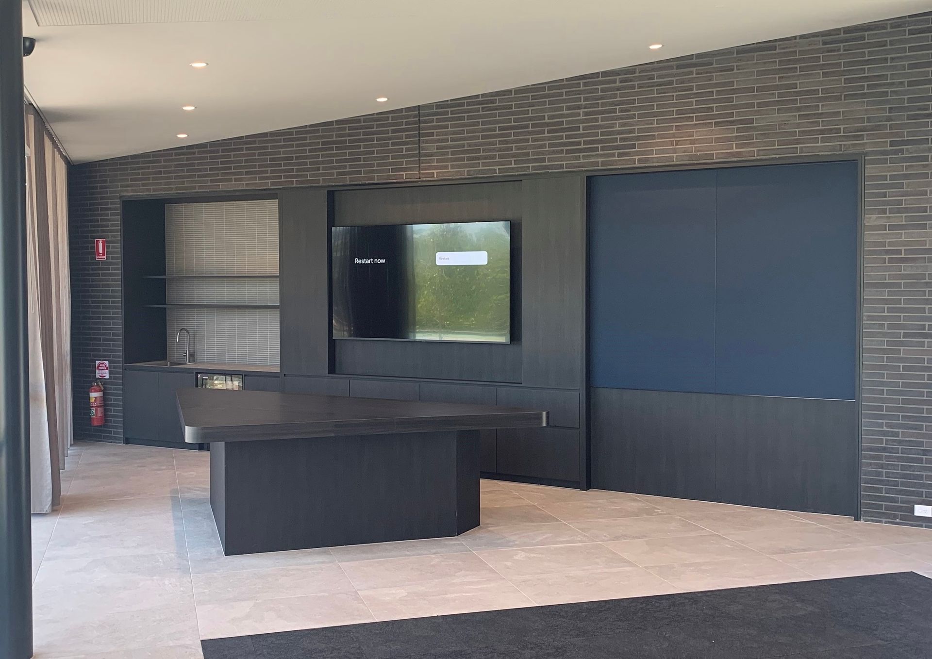 A Large Empty Patio With A Table And TV - Viison Kitchens & Joinery Forster In Forster, NSW