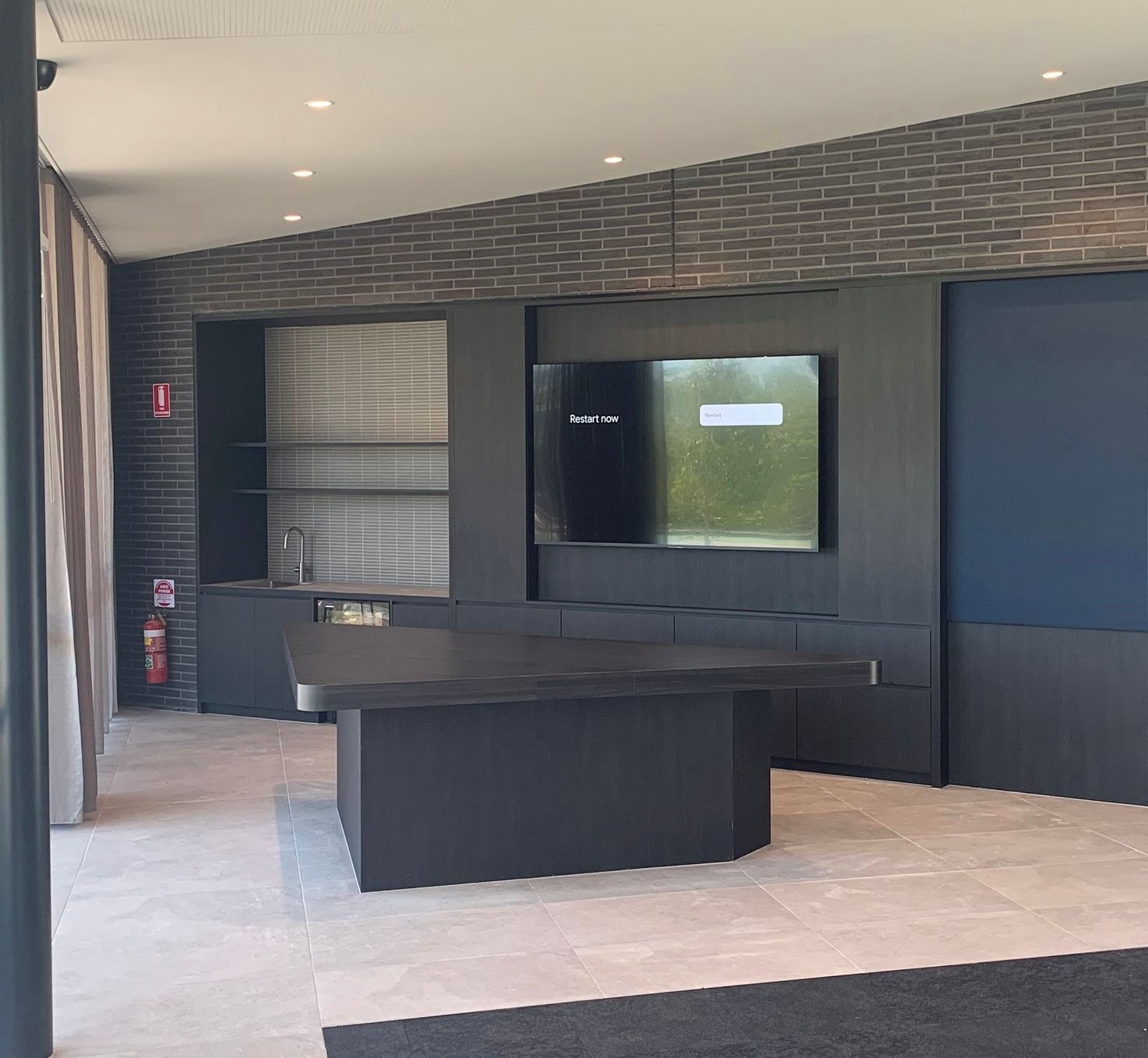 A Large Empty Patio With Shelving And A TV — Viison Kitchens & Joinery Forster In Forster, NSW