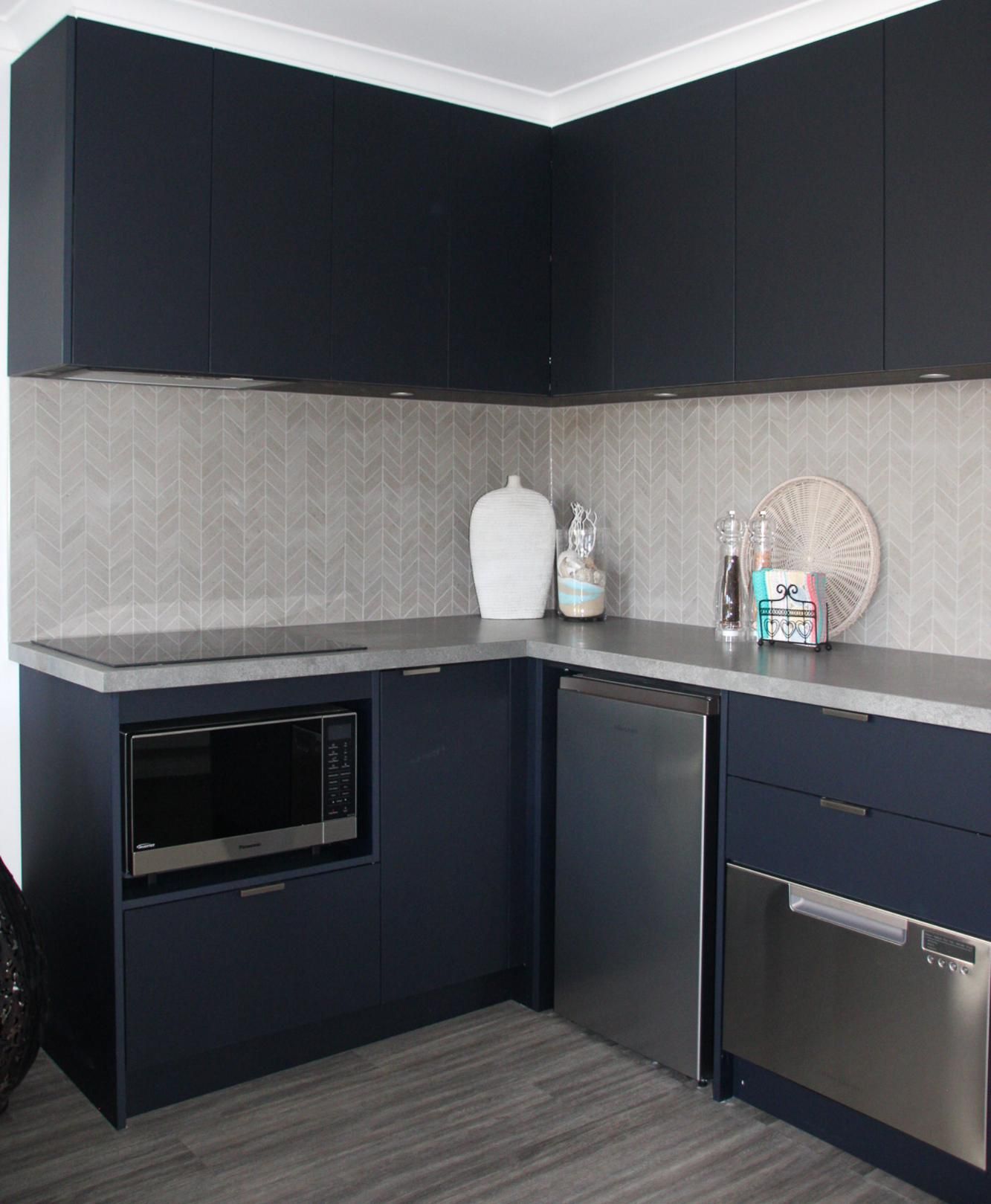 A Kitchen With Black Cabinets And Stainless Steel Appliances — Viison Kitchens & Joinery Forster In Taree, NSW